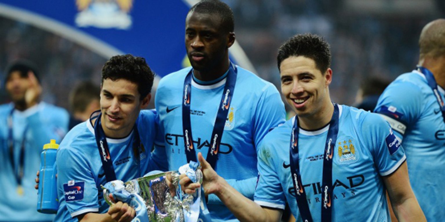 Jesus-Navas-Yaya-Toure-and-Samir-Nasri-of-Manchester-City-pose-with-the-trophy-after-the-Capital-One-Cup-Final-